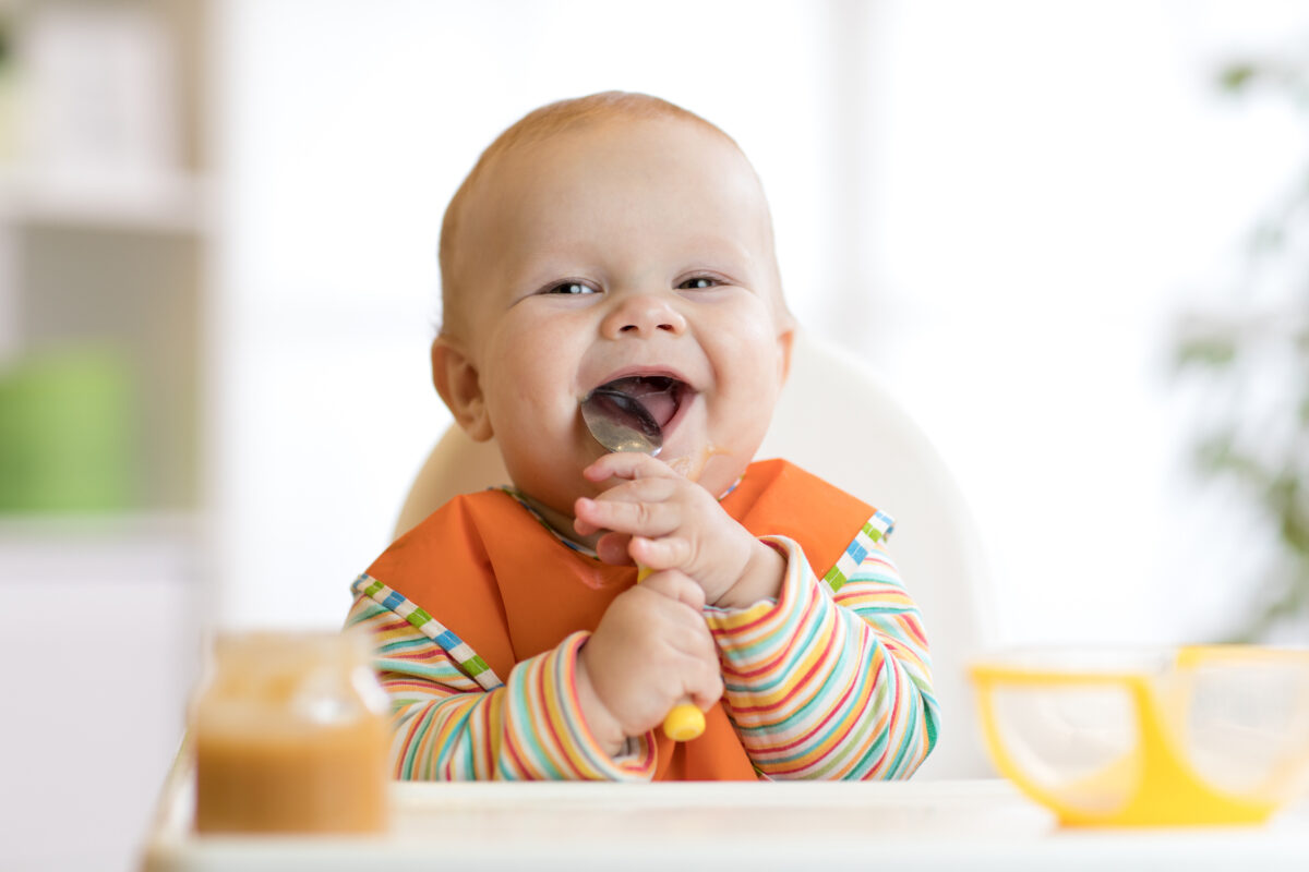 infant trying solid foods